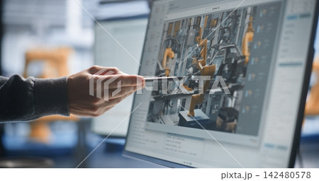 Specialist Pointing to Live Robotic Welding Video Stream on Screen Specialist Pointing to Live Robotic Welding Video Stream on Screen 142480578