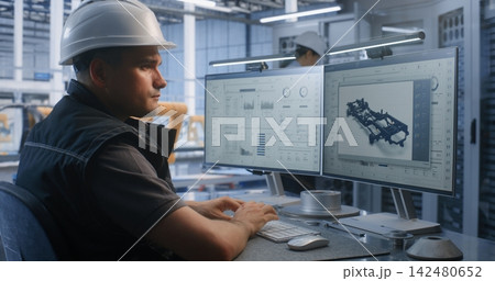 Engineer Analyzing Production Workflows on Dual Screens in Smart Factory Engineer Analyzing Production Workflows on Dual Screens in Smart Factory 142480652