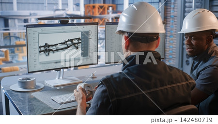 Engineer Consulting Male Colleague on 3D CAD Model in Factory Engineer Consulting Male Colleague on 3D CAD Model in Factory 142480719