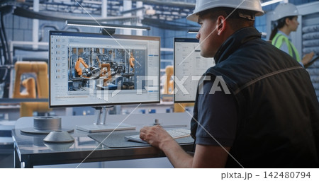 Engineer Monitoring 3D Chassis Design and Data on Screen in Smart Car Factory Engineer Monitoring 3D Chassis Design and Data on Screen in Smart Car Factory 142480794