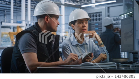 Male and Female Engineers Verifying Metal Part Dimensions in Smart Plant Male and Female Engineers Verifying Metal Part Dimensions in Smart Plant 142480805