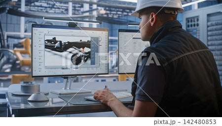 Engineer Monitoring 3D Chassis Design and Data on Screen in Smart Car Factory Engineer Monitoring 3D Chassis Design and Data on Screen in Smart Car Factory 142480853
