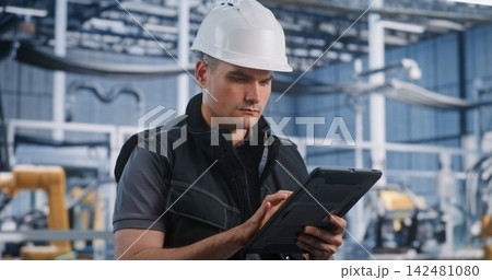 Factory Engineer Using Digital Tablet for Maintenance and Diagnostics Factory Engineer Using Digital Tablet for Maintenance and Diagnostics 142481080