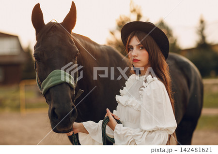 Woman with her horse at outdoors ranch Woman with her horse at outdoors ranch 142481621