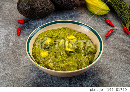 Indian palak paneer curry with fresh spinach and cottage cheese in bowl on dark background 142481730