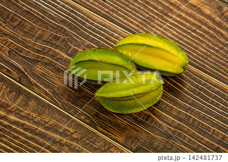 Fresh carambola star fruits on dark rustic wooden background 142481737