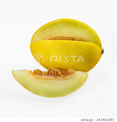 Yellow honeydew melon cut in half with one slice on white background Yellow honeydew melon cut in half with one slice on white background 142481893