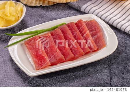 Raw tuna sashimi slices with ginger and green onion Raw tuna sashimi slices with ginger and green onion 142481978