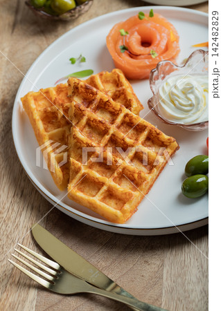 Crunchy waffle fries with sour cream dip served in a basket Crunchy waffle fries with sour cream dip served in a basket 142482829