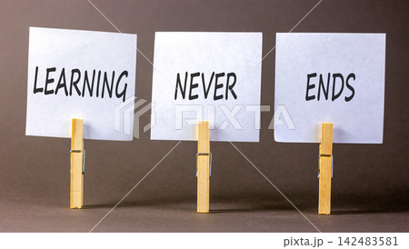Learning never ends words symbol. Concept words Learning never ends on beautiful white papers. Beautiful grey background. Business support motivational and learning never ends concept. Copy space. 142483581
