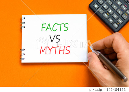 Facts vs versus myths words symbol. Concept words Facts vs Myths on beautiful white note. Beautiful orange background. Businessman hand. Business and facts vs versus myths concept. Copy space. Facts vs versus myths words symbol. Concept words Facts vs Myths on beautiful white note. Beautiful orange background. Businessman hand. Business and facts vs versus myths concept. Copy space. 142484121