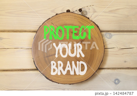 Protect your brand words symbol. Concept words Protect your brand on beautiful wooden circle. Beautiful wooden wall background. Business and protect your brand concept. Copy space. Protect your brand words symbol. Concept words Protect your brand on beautiful wooden circle. Beautiful wooden wall background. Business and protect your brand concept. Copy space. 142484787