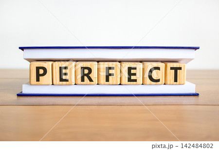 Perfect word symbol. Concept word Perfect on beautiful wooden blocks in book. Beautiful wooden table white background. Business perfect word concept. Copy space. 142484802