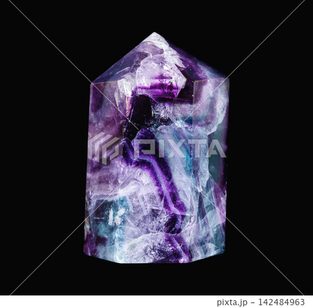 Polished Rainbow Fluorite Crystal Point on Black Background Polished Rainbow Fluorite Crystal Point on Black Background 142484963