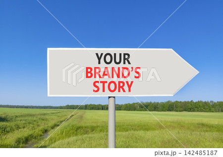 Branding and your brands story symbol. Concept words Your brands story on beautiful grey road sign. Beautiful blue sky green grass background. Business branding your brands story concept. Copy space Branding and your brands story symbol. Concept words Your brands story on beautiful grey road sign. Beautiful blue sky green grass background. Business branding your brands story concept. Copy space 142485187