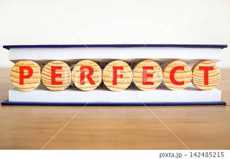 Perfect word symbol. Concept word Perfect on beautiful wooden circles in book. Beautiful wooden table white background. Business perfect word concept. Copy space. Perfect word symbol. Concept word Perfect on beautiful wooden circles in book. Beautiful wooden table white background. Business perfect word concept. Copy space. 142485215