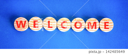 Welcome word symbol. Concept word Welcome on beautiful wooden circles. Beautiful blue background. Business welcome word concept. Copy space. Welcome word symbol. Concept word Welcome on beautiful wooden circles. Beautiful blue background. Business welcome word concept. Copy space. 142485649
