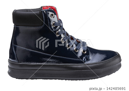 Dark blue patent leather high top sneaker boot isolated on white background. Womens casual laced shoe profile view Dark blue patent leather high top sneaker boot isolated on white background. Womens casual laced shoe profile view 142485691