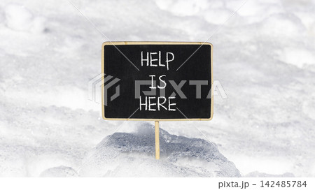 Help is here and support words symbol. Concept words Help is here on beautiful black blackboard. Beautiful white snow background. Business help is here and support concept. Copy space. Help is here and support words symbol. Concept words Help is here on beautiful black blackboard. Beautiful white snow background. Business help is here and support concept. Copy space. 142485784
