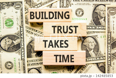 Building trust takes time words symbol. Concept words Building trust takes time on beautiful wooden blocks. Beautiful dollar bills background. Business building trust takes time concept. Copy space. Building trust takes time words symbol. Concept words Building trust takes time on beautiful wooden blocks. Beautiful dollar bills background. Business building trust takes time concept. Copy space. 142485853