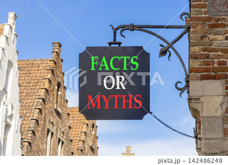 Facts or myths words symbol. Concept words Myths or Facts on beautiful black road sign. Beautiful blue sky Brugge street background. Business and facts or myths concept. Copy space. Facts or myths words symbol. Concept words Myths or Facts on beautiful black road sign. Beautiful blue sky Brugge street background. Business and facts or myths concept. Copy space. 142486249