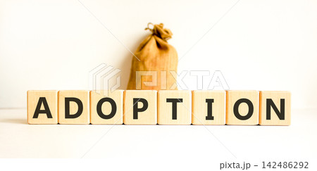 Adoption word symbol. Concept word Adoption on beautiful wooden blocks. Beautiful white background. Beautiful canvas bag. Business psychological support help adoption word concept. Copy space. Adoption word symbol. Concept word Adoption on beautiful wooden blocks. Beautiful white background. Beautiful canvas bag. Business psychological support help adoption word concept. Copy space. 142486292