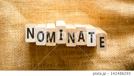 Nominate word symbol. Concept word Nominate on beautiful wooden blocks. Beautiful canvas background. Business support help nominate word concept. Copy space. 142486293