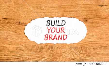 Build your brand words symbol. Concept words Build your brand on beautiful white paper. Beautiful wooden background. Business and build your brand concept. Copy space. Build your brand words symbol. Concept words Build your brand on beautiful white paper. Beautiful wooden background. Business and build your brand concept. Copy space. 142486689