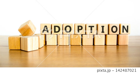 Adoption word symbol. Concept word Adoption on beautiful wooden blocks. Beautiful wooden table white background. Business psychological support help adoption word concept. Copy space. Adoption word symbol. Concept word Adoption on beautiful wooden blocks. Beautiful wooden table white background. Business psychological support help adoption word concept. Copy space. 142487021