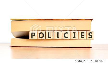 Policies word symbol. Concept word Policies on beautiful wooden blocks in beautiful book. Beautiful wooden table white background. Business support help policies word concept. Copy space. Policies word symbol. Concept word Policies on beautiful wooden blocks in beautiful book. Beautiful wooden table white background. Business support help policies word concept. Copy space. 142487022