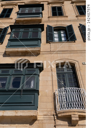 Historic building facade with traditional green wooden balconies and shutters in Malta. Historic building facade with traditional green wooden balconies and shutters in Malta. 142487974