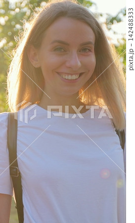 Vertical video. Woman posing with electric scooter in city sunset. Vertical video. Woman posing with electric scooter in city sunset. 142488333