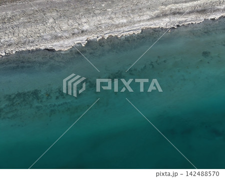 texture, background. aerial view coastli. sunbeams from behind the clouds over the lakes. view from a drone of a lake in the mountains. High quality 4k footage texture, background. aerial view coastli. sunbeams from behind the clouds over the lakes. view from a drone of a lake in the mountains. High quality 4k footage 142488570