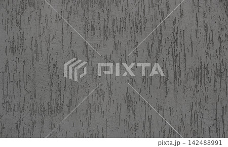 A pattern of indentations on a flat surface of decorative plaster. Ornamental concrete stucco texture  142488991