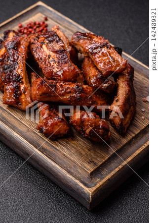 Grilled pork or beef ribs seasoned with salt and spices, served in sauce. Grilled ribs Grilled pork or beef ribs seasoned with salt and spices, served in sauce. Grilled ribs 142489321