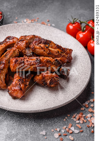 Grilled pork or beef ribs seasoned with salt and spices, served in sauce. Grilled ribs Grilled pork or beef ribs seasoned with salt and spices, served in sauce. Grilled ribs 142489331