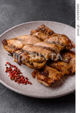Grilled chicken breast seasoned with salt and spices. Grilled chicken Grilled chicken breast seasoned with salt and spices. Grilled chicken 142489360