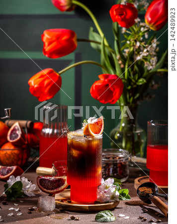 Refreshing iced coffee with blood orange and flowers Refreshing iced coffee with blood orange and flowers 142489923