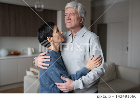 Senior anxious couple embracing comforting each other. Love support, health issues, emotional bond Senior anxious couple embracing comforting each other. Love support, health issues, emotional bond 142491666
