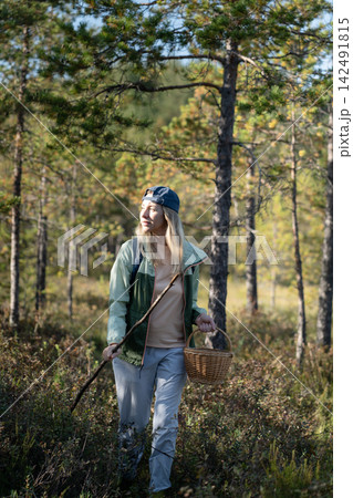 Confident woman backpacker strolling through forest, physical activity outdoors and healthy living 142491815