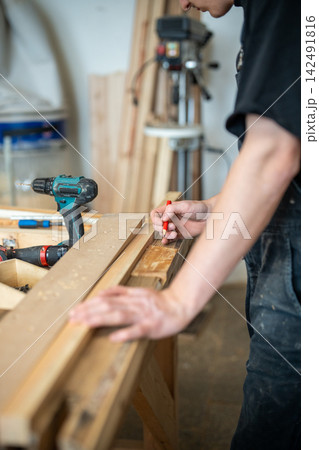 Preparation process in restoration workshop, man crafter working with wooden details and materials. Preparation process in restoration workshop, man crafter working with wooden details and materials. 142491816