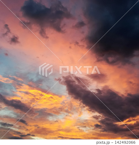 flaming orange clouds in the evening twilight sky flaming orange clouds in the evening twilight sky 142492066