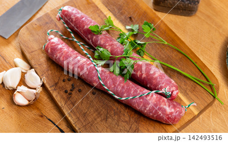 Sausages served with herbs to table Sausages served with herbs to table 142493516