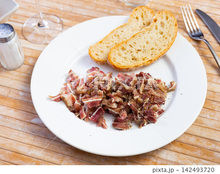 Sliced pig ears served on platter 142493720