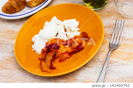 Caramelized peaches and light, tender cottage cheese with sour cream closeup 142493742