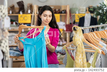 Armenian woman chooses a summer dress on sale 142493752