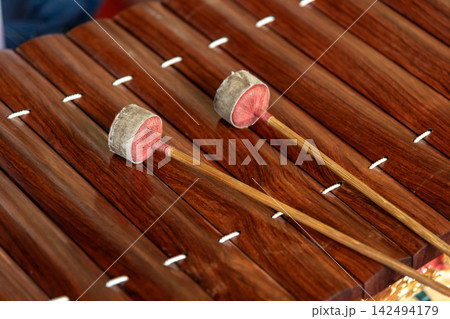 Traditional Thai xylophone mallets resting polished wooden bars highlighting musical heritage craftsmanship rhythm cultural performance 142494179