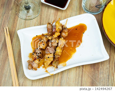 Traditional Yakitori made of chicken pieces served in a plate Traditional Yakitori made of chicken pieces served in a plate 142494267