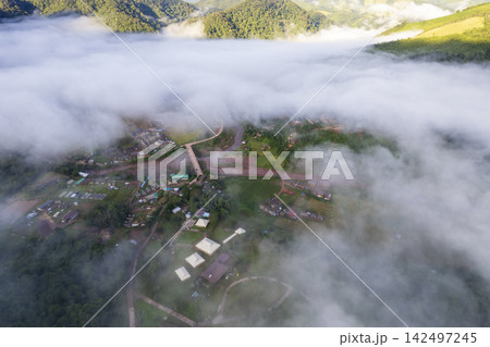 Landscape of Morning Mist with Mountain Layer. mountain ridge and clouds in rural jungle bush forest Landscape of Morning Mist with Mountain Layer. mountain ridge and clouds in rural jungle bush forest 142497245