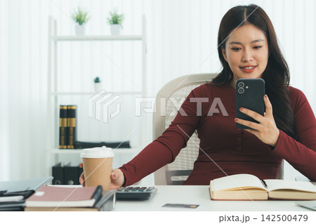 Young Asian Woman Studying Online with Laptop, Tablet, Smartphone and Headphones at Home, Adult Education and E-Learning Young Asian Woman Studying Online with Laptop, Tablet, Smartphone and Headphones at Home, Adult Education and E-Learning 142500479
